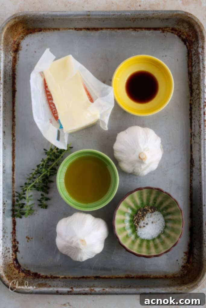 Ingredients for roasted garlic compound butter recipe laid out on a cutting board