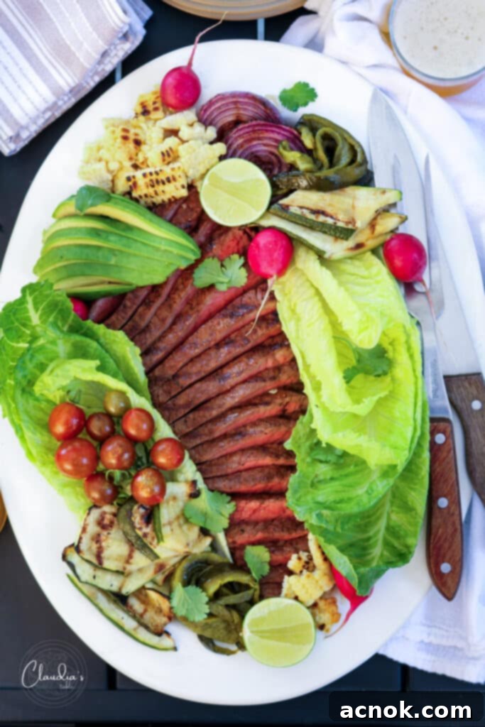 grilled steak salad with jalapeño dressing on white platter