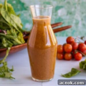 Freshly made Balsamic Vinaigrette in a glass cruet, ready to be poured.