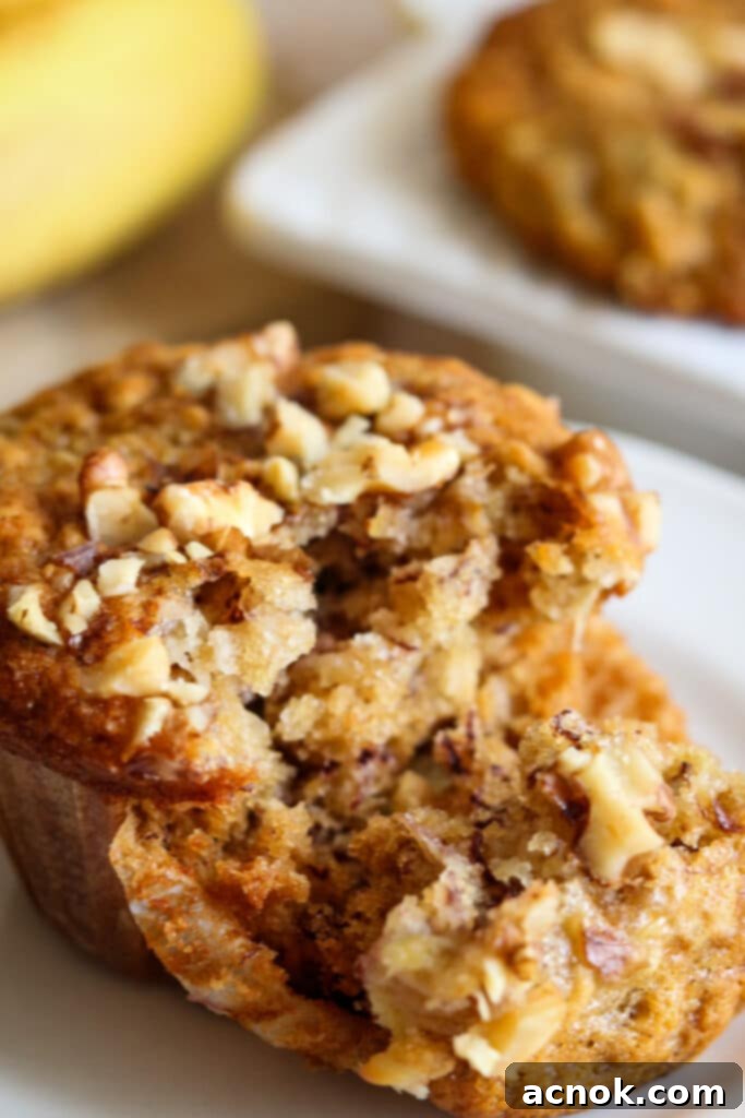 Close-up of a moist banana and oat muffin, showcasing its fluffy interior and golden crust.