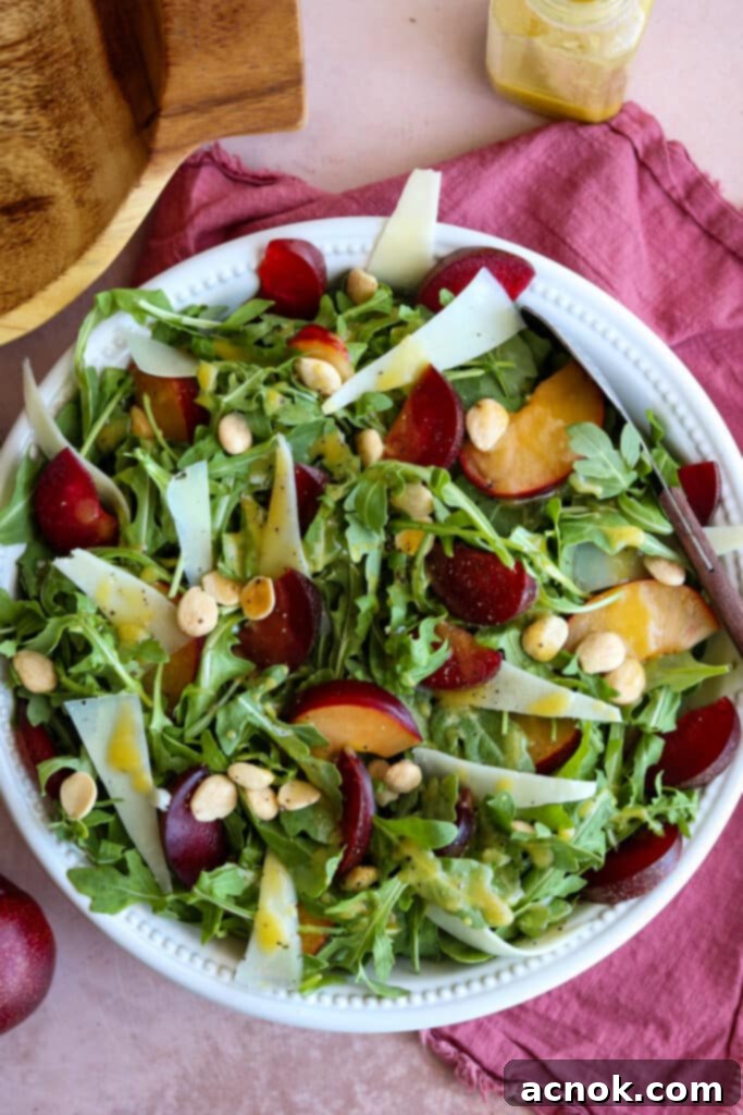 Plum salad with Manchego and Marcona almonds, showcasing vibrant colors and fresh ingredients.