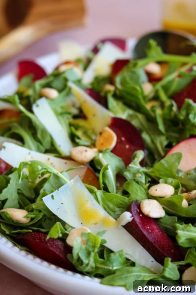 Close-up of Plum Salad with Manchego and Marcona Almonds, highlighting texture and detail.