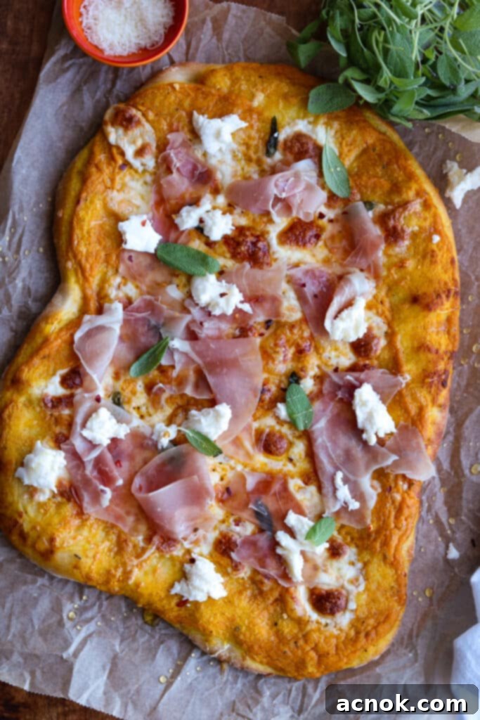 Pumpkin pizza with prosciutto and sage, beautifully garnished and ready to serve.