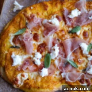 Close-up of a pumpkin pizza with prosciutto, sage, and honey drizzle