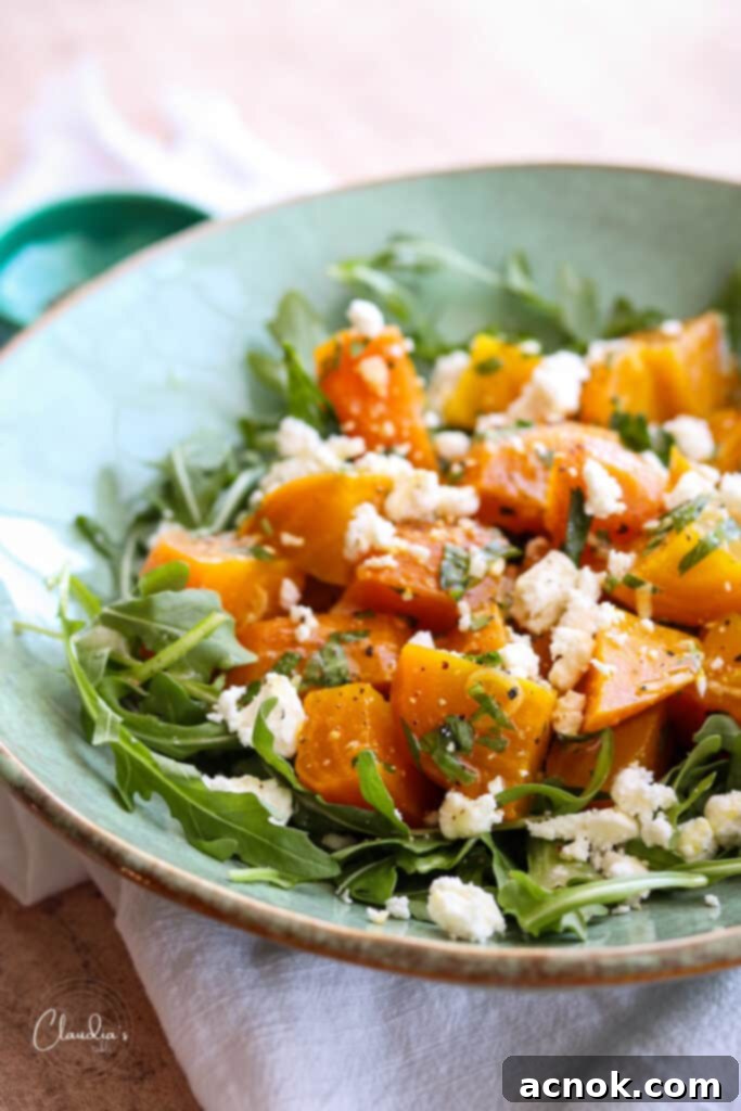 Close-up of roasted beets, feta, and fresh herbs beautifully arranged in a salad