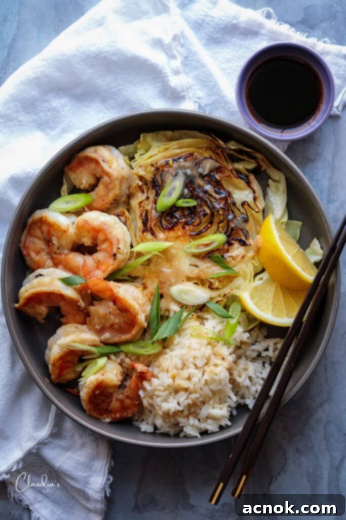 Delicious Miso Butter Shrimp served with charred cabbage and steamed rice, highlighting the vibrant sauce.