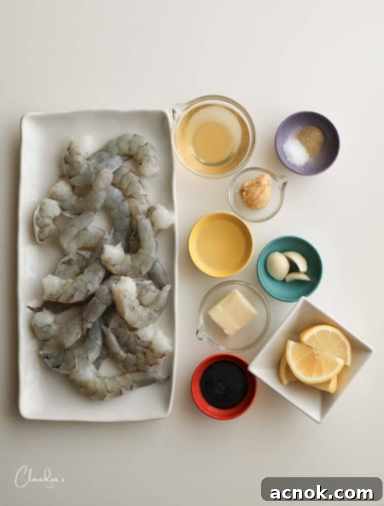 A flat lay photograph showing all the fresh ingredients for Miso Butter Shrimp laid out on a white background.