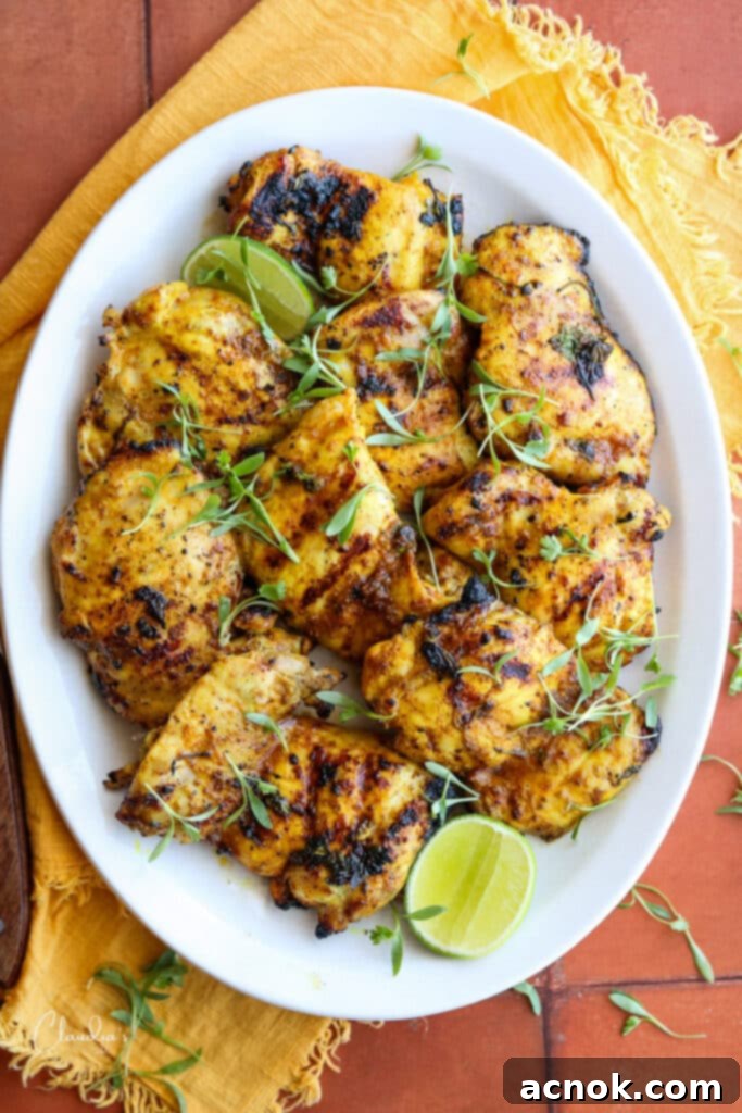 grilled citrus marinated boneless chicken thigh recipe on white platter with cilantro garnish