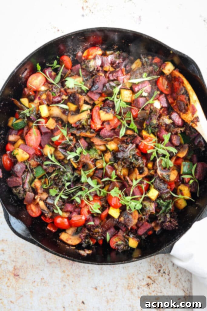 Vegetable hash with sweet potatoes and micro cilantro on black skillet