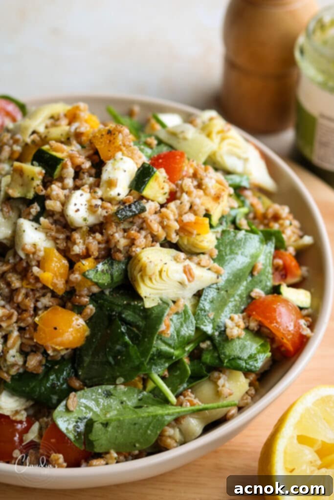 Delicious and nutritious Farro Salad with Pesto and Vegetables in a large bowl, ready to serve.