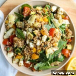 close up of farro salad in bowl with lemon