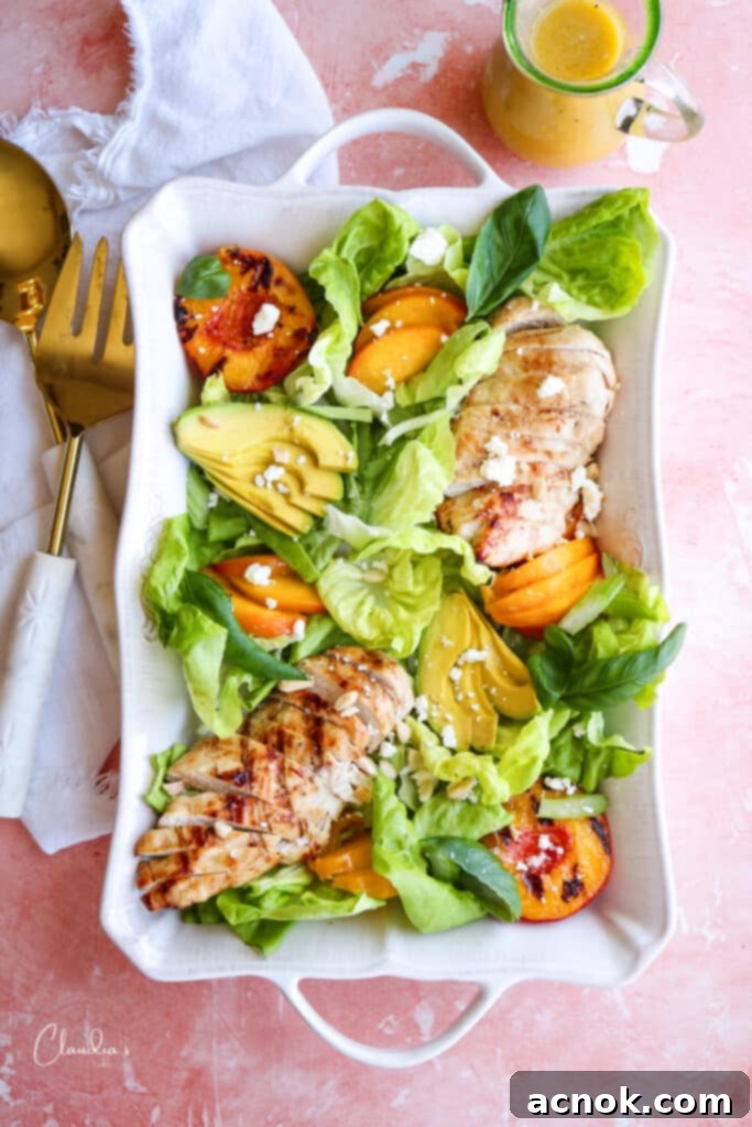 Grilled Peach Avocado Chicken Salad on a white platter with feta cheese